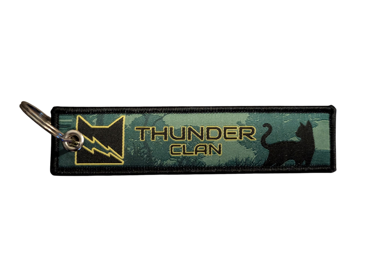 Keychain with 'Thunder Clan' logo and design on a green background